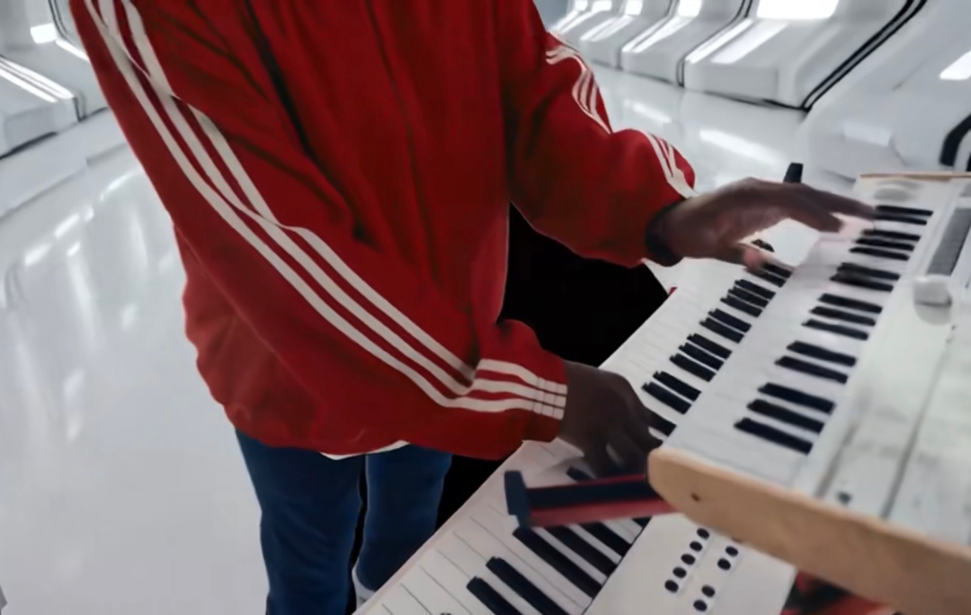 Close-up of BAM playing stacked keyboards